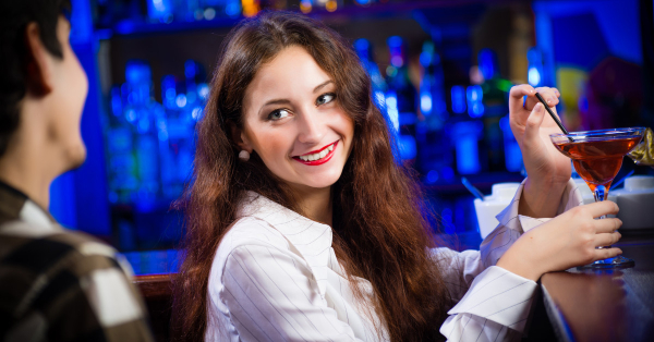 girl at bar with cocktail flirting