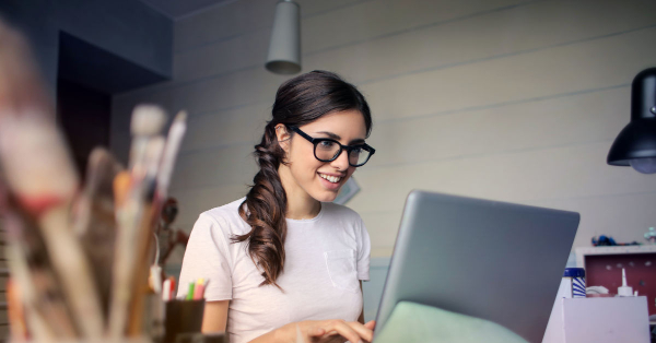 smiling woman on computer
